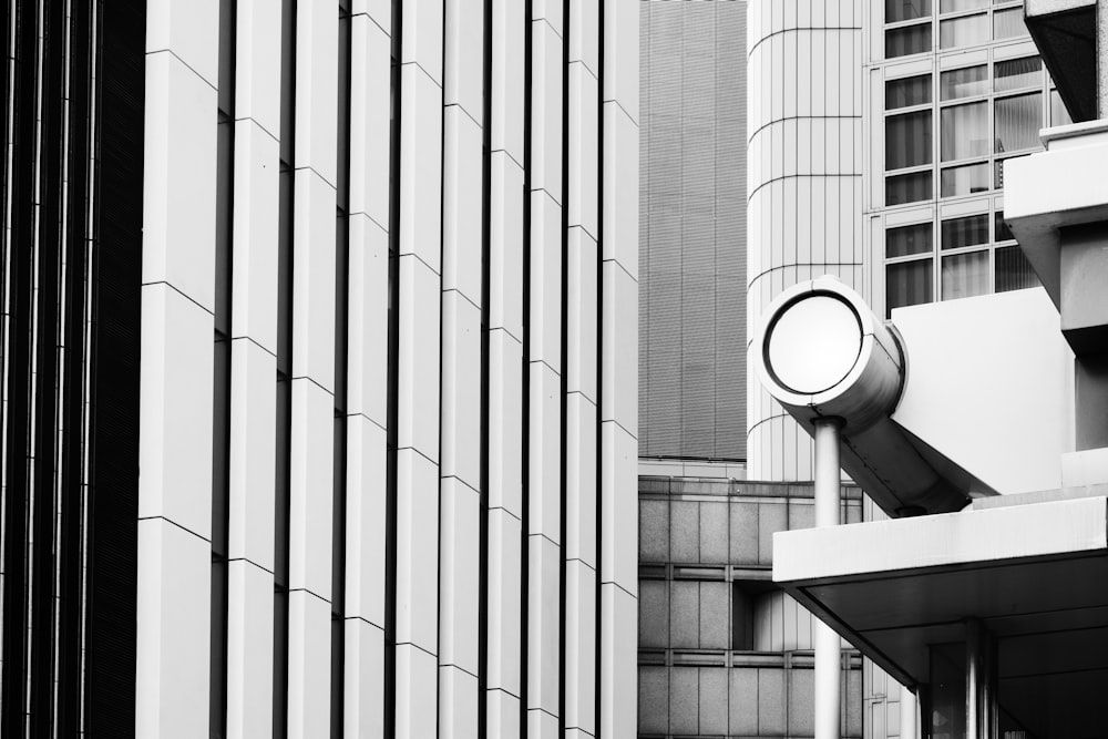 grayscale photo of round wall mounted light