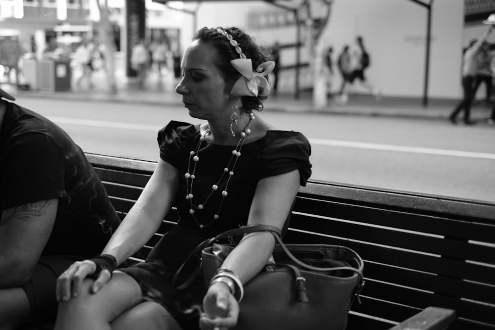 woman in black and white shirt sitting on bench