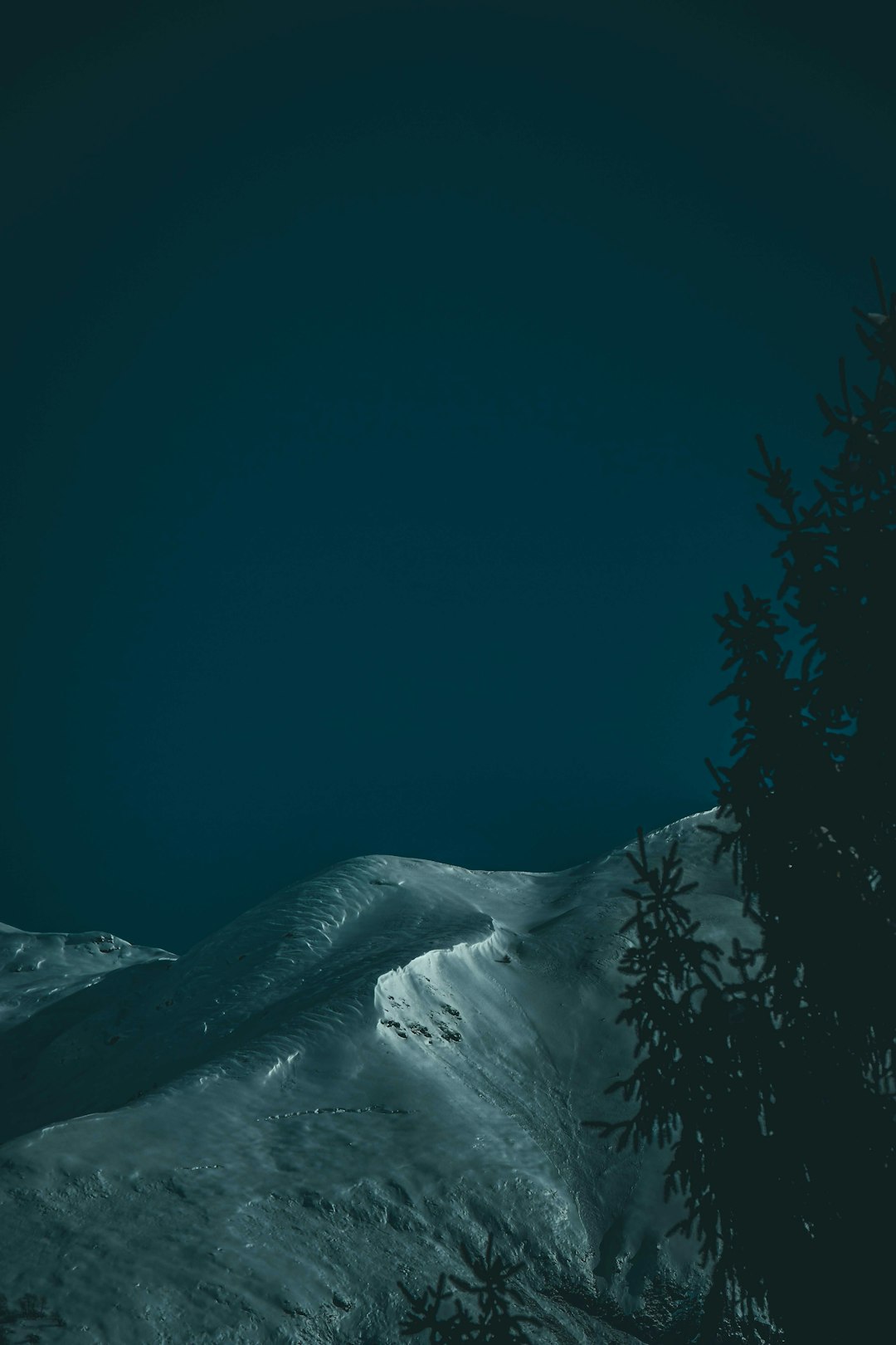 snow covered mountain during night time