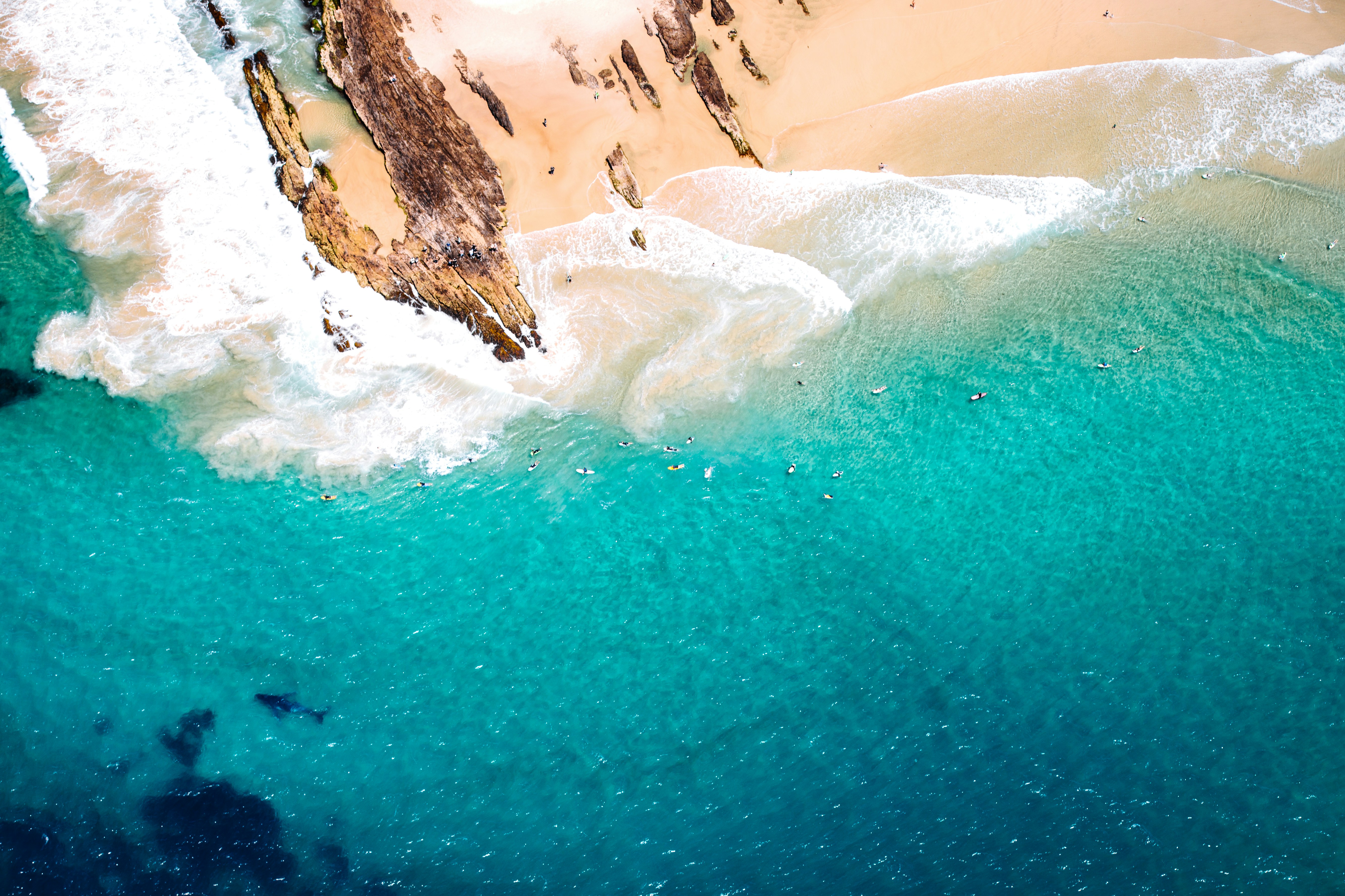 brown rock formation near body of water during daytime