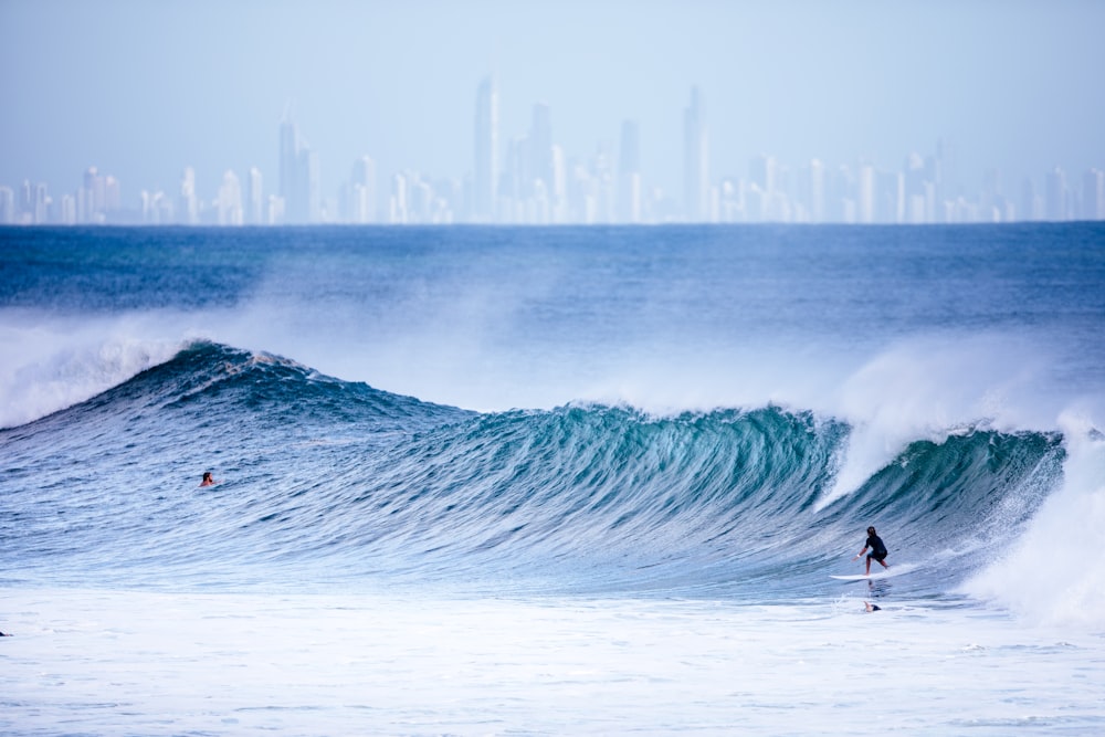 person surfing on sea waves during daytime