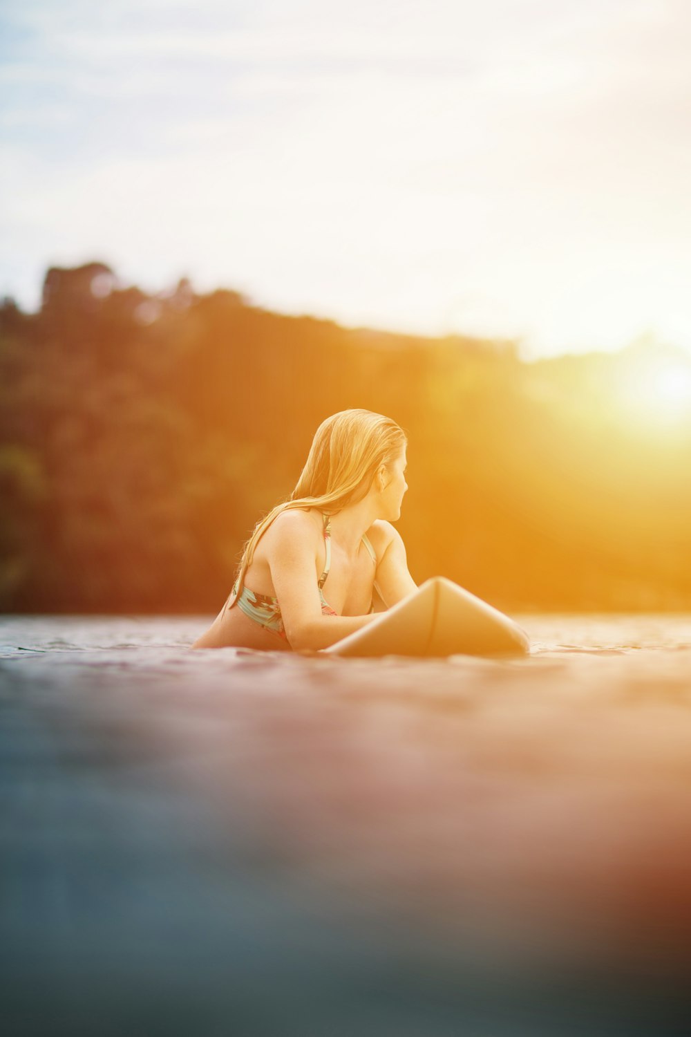 woman in yellow bikini lying on beach during sunset