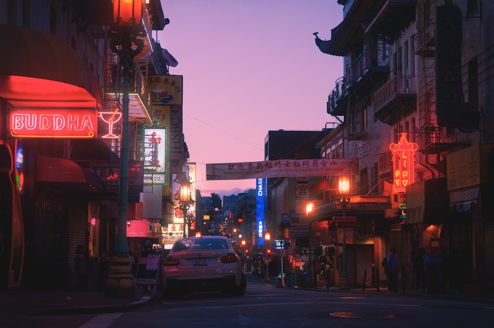 cars on road near buildings during night time