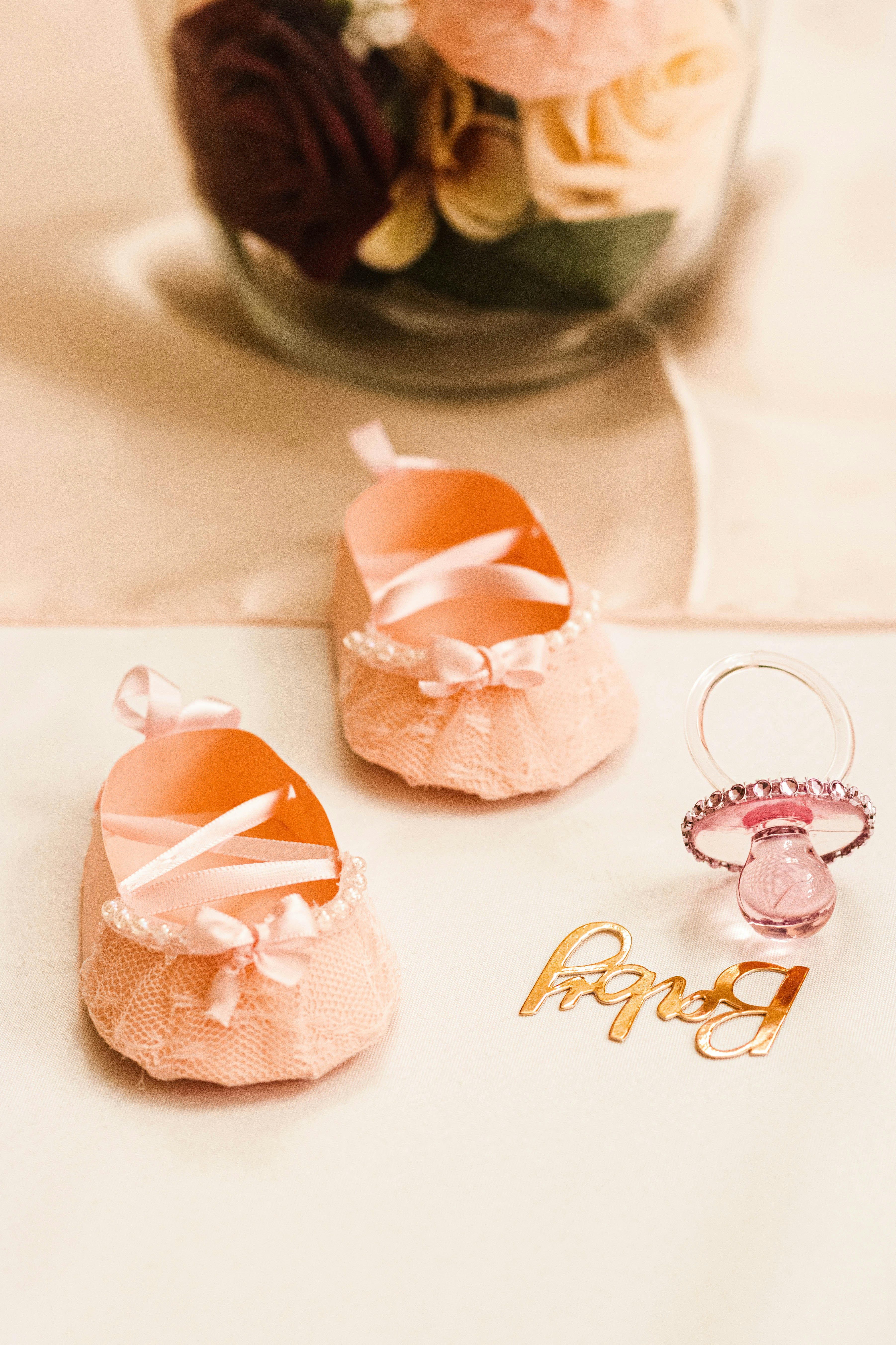 An elegant baby shower setup with soft pastel decorations and delicate floral arrangements