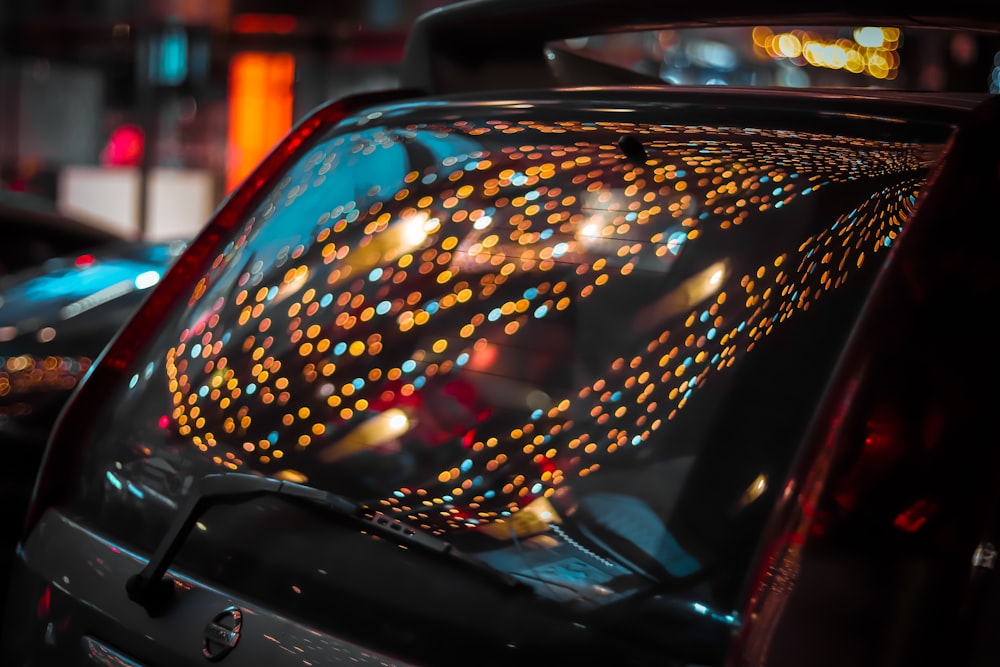 black car with lights on during night time