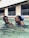 A happy family enjoying their clean pool during summer.