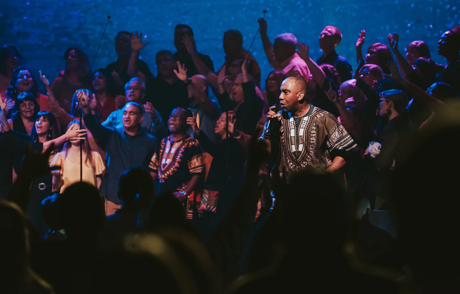 A singer leading worship in front of a crowd