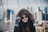 A stylish woman wearing a cozy hoodie in an urban setting.