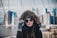 A stylish woman wearing a cozy hoodie in an urban setting.