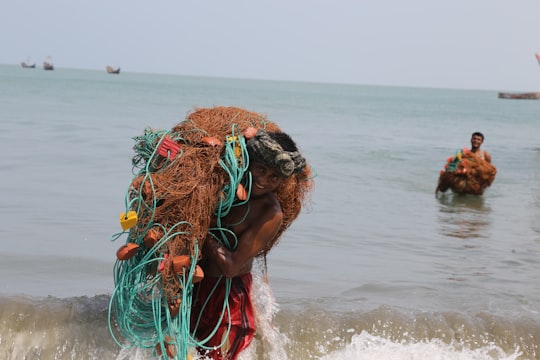 woman in green and orange hair tie on beach during daytime in St. Martin's Island Bangladesh