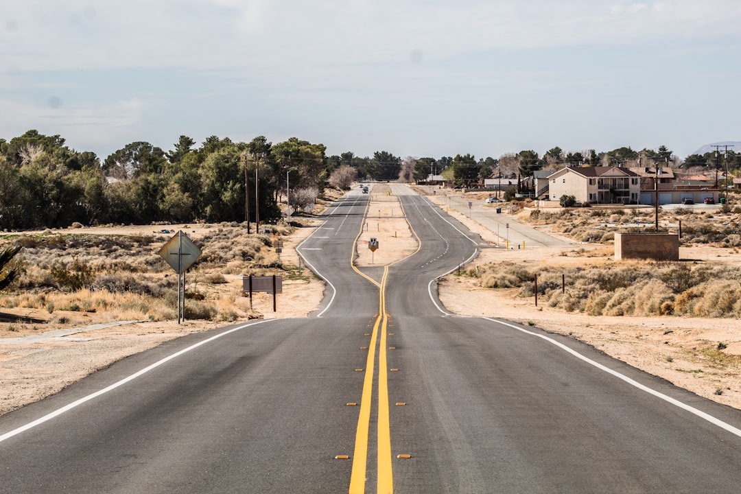 gray asphalt road under white sky during daytime