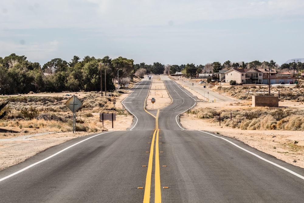 gray asphalt road under white sky during daytime