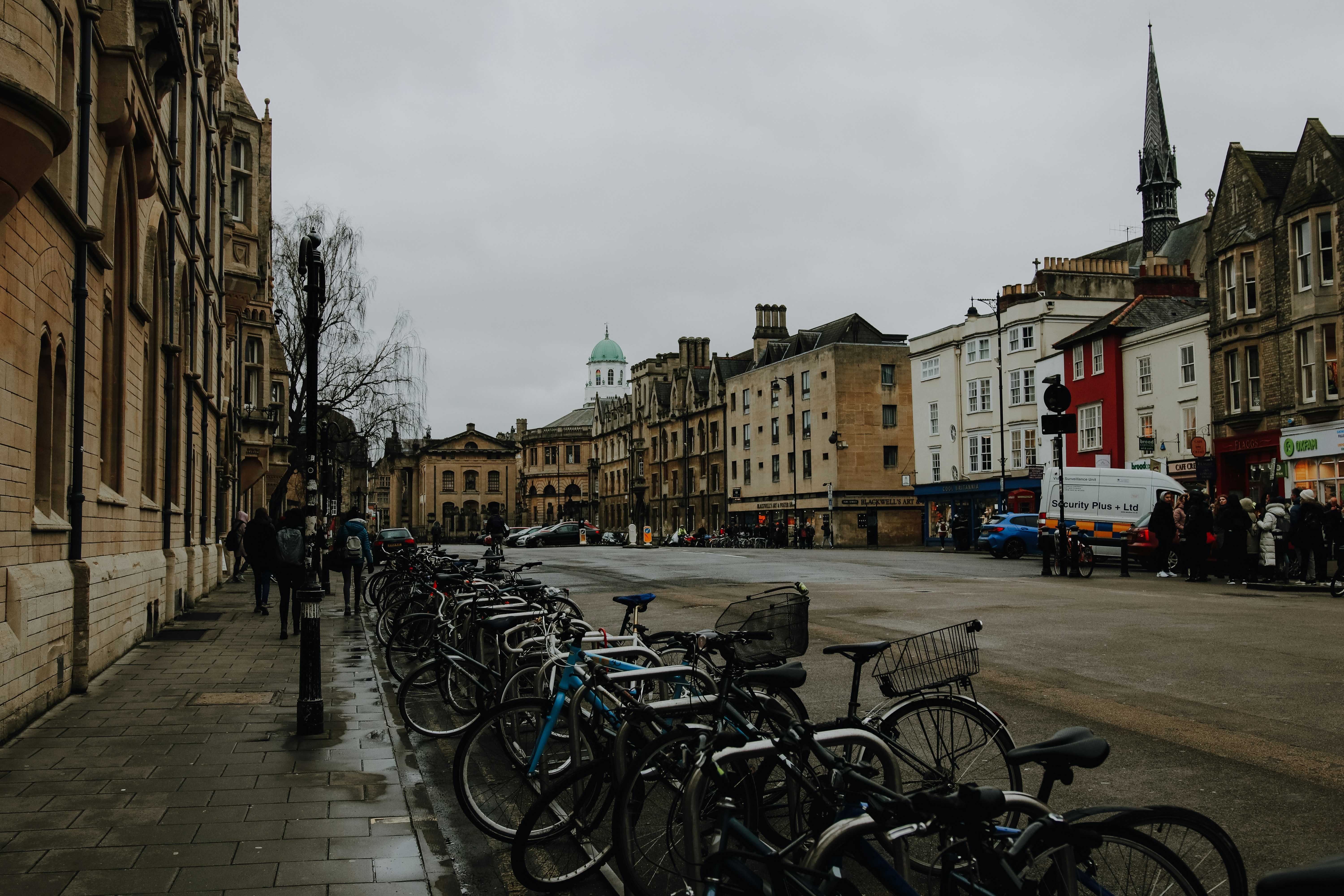bicycles parked on sidewalk near brown concrete building during daytime