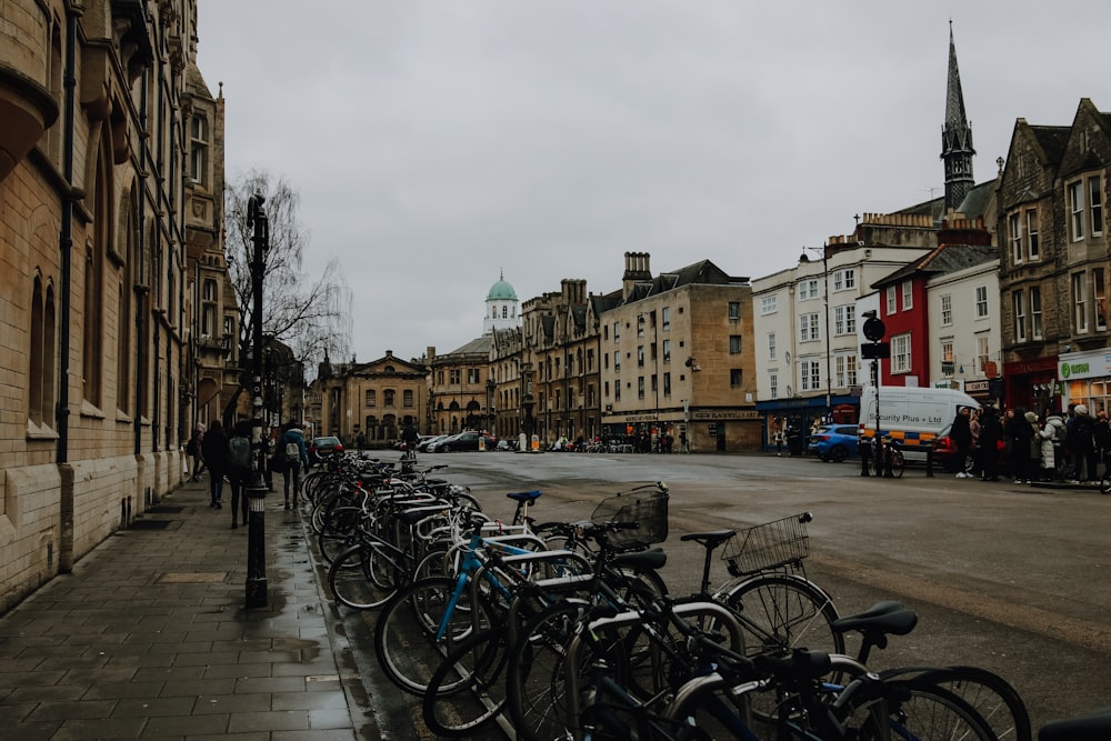 bicycles parked on sidewalk near brown concrete building during daytime