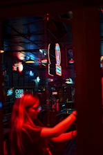 Urban night scene with neon lights and cold drinks on a sleek counter.