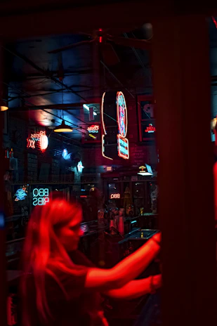 Urban night scene with neon lights and cold drinks on a sleek counter.