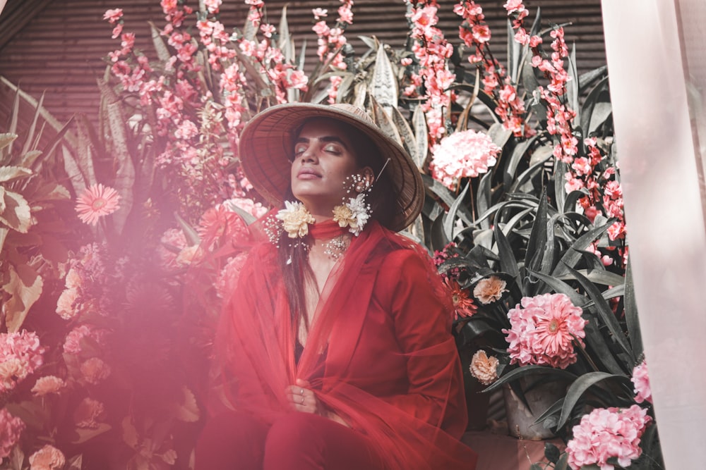 woman in red long sleeved dress wearing white floral headdress