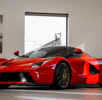 red ferrari 458 italia parked in front of white wall