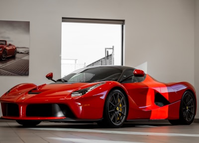 red ferrari 458 italia parked in front of white wall