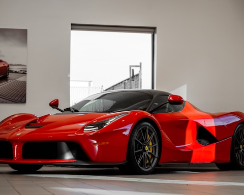 red ferrari 458 italia parked in front of white wall