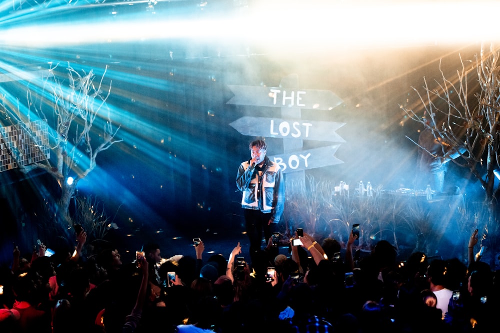 man in black jacket standing on stage