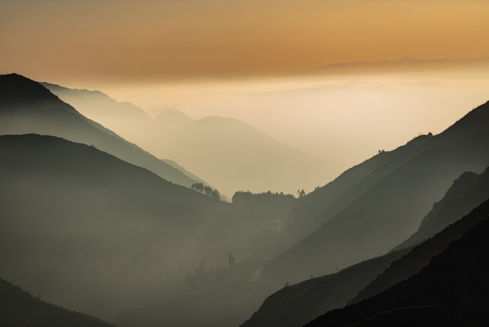 mountains under white clouds during daytime