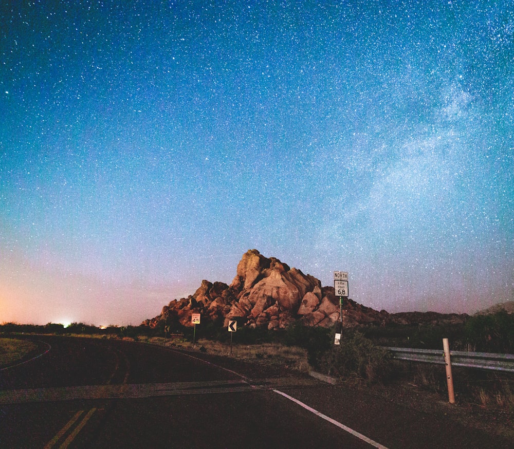 brown rock formation under blue sky during night time