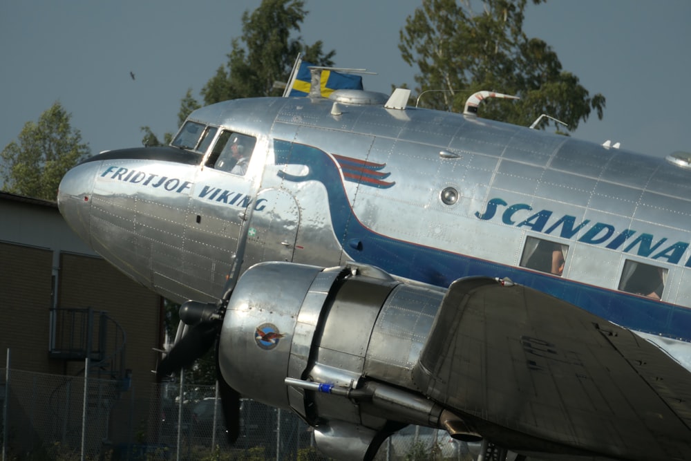 white and blue passenger plane