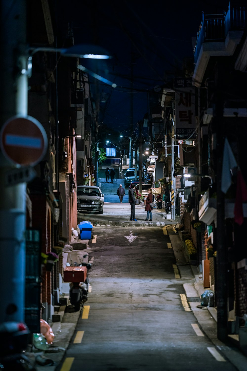 red and black shopping cart on the street during night time