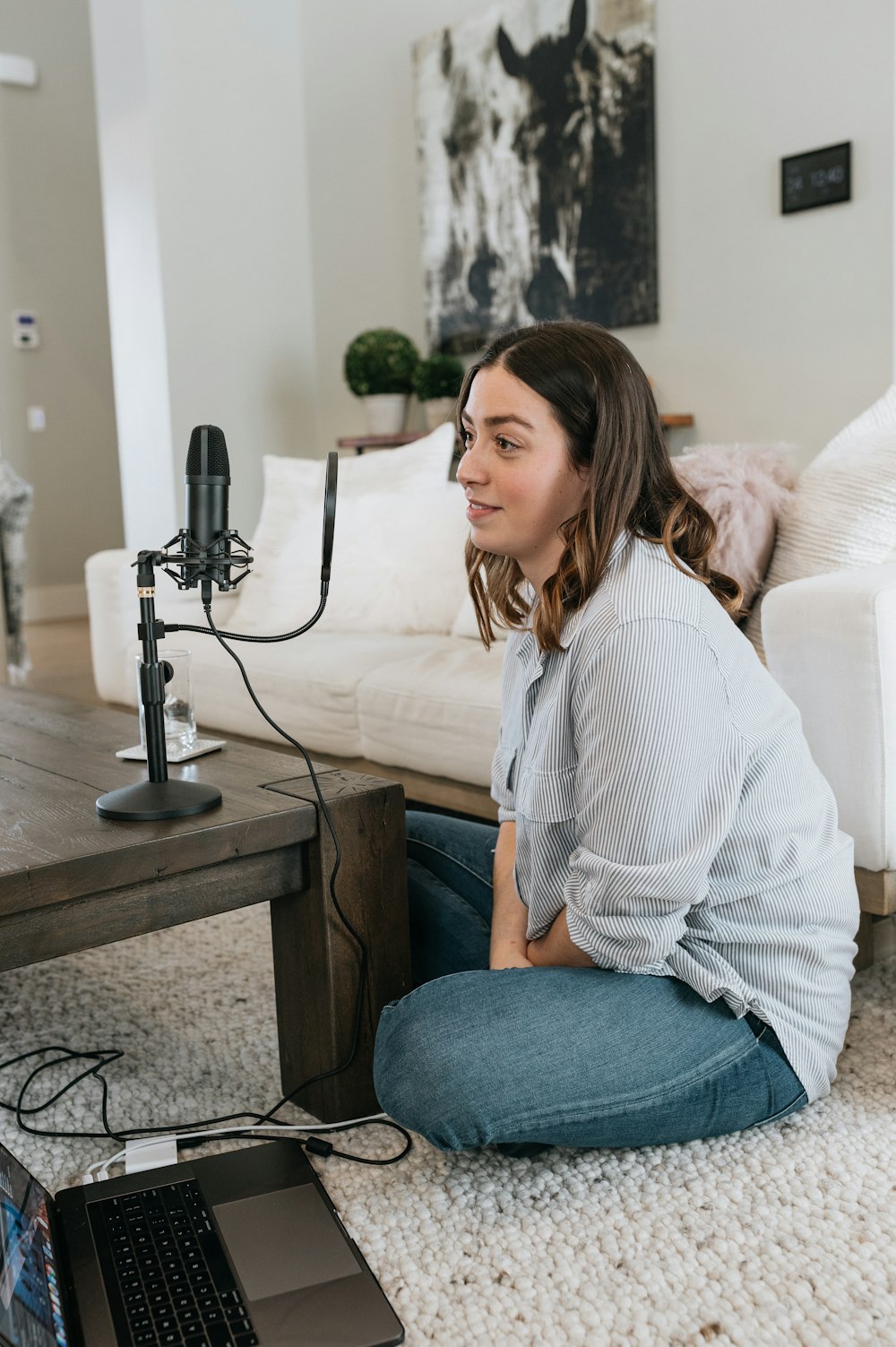 woman in white long sleeve shirt and blue denim jeans sitting on white couch