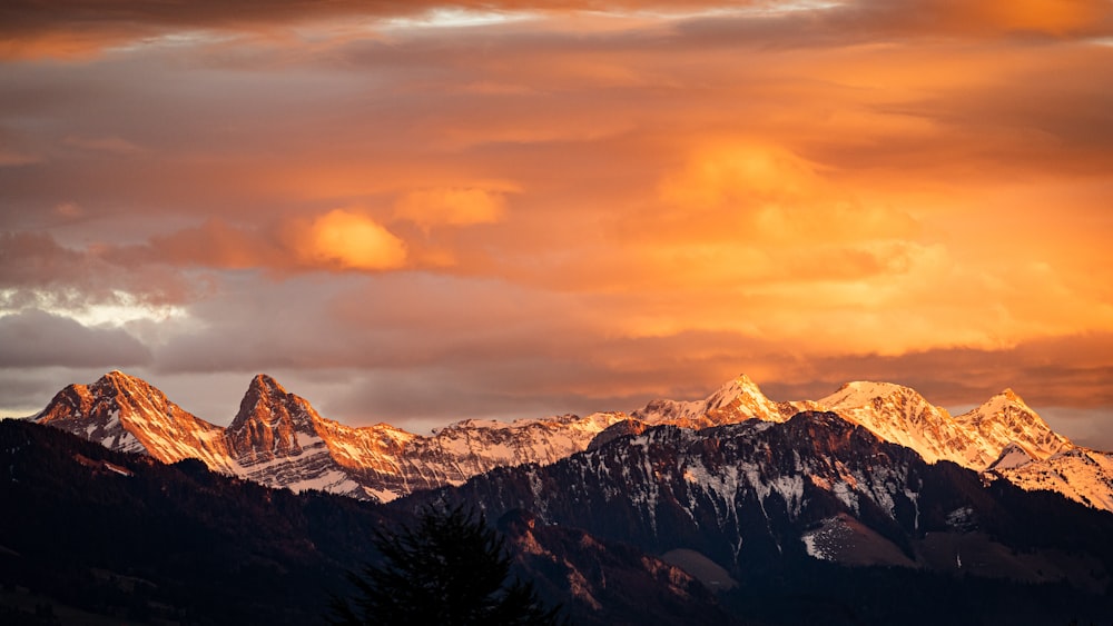 snow covered mountain under cloudy sky during daytime