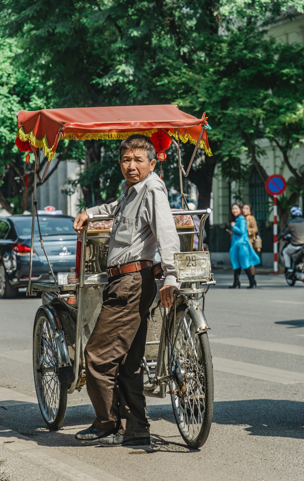 man in brown and white long sleeve shirt riding on bicycle during daytime