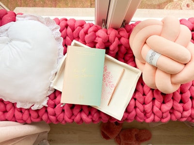 Vintage-style kitchen pillows with embroidered details resting on a window seat.