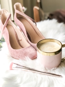 Elegant women's sneakers displayed alongside soft, harmonious makeup brushes and colors.