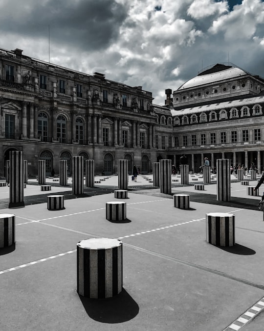 people walking around brown concrete building during daytime in Jardin du Palais Royal France