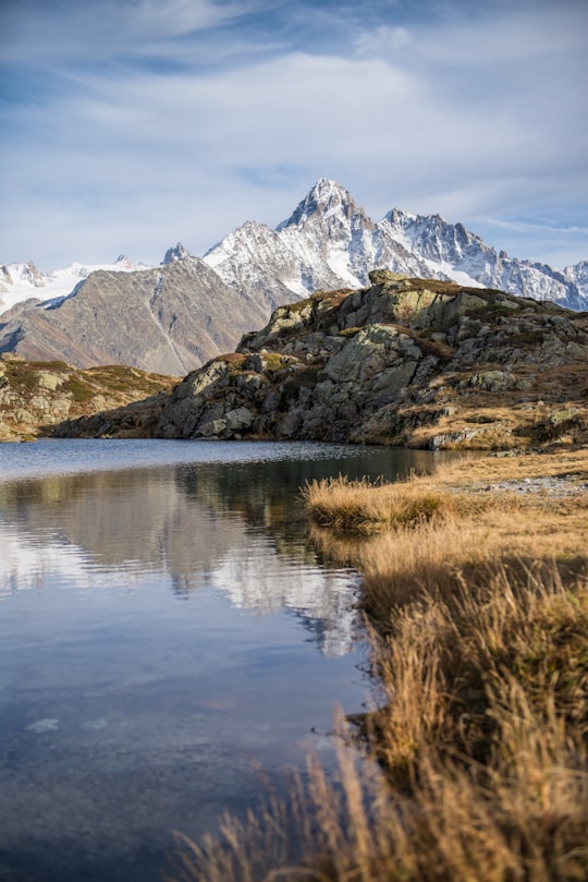 body of water near mountain during daytime in Lac Blanc France