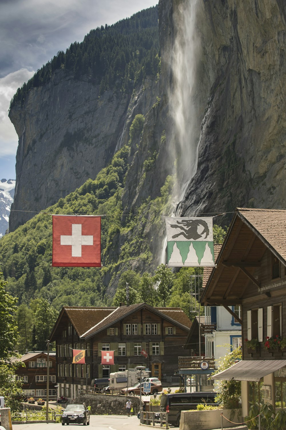 brown wooden house near waterfalls during daytime