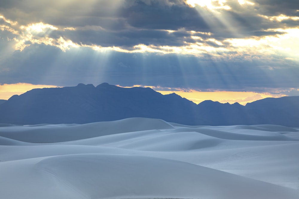 snow covered mountain under cloudy sky during daytime