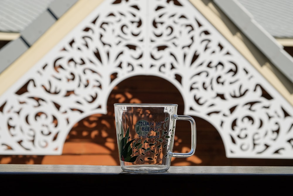 black and white ceramic mug on brown wooden table