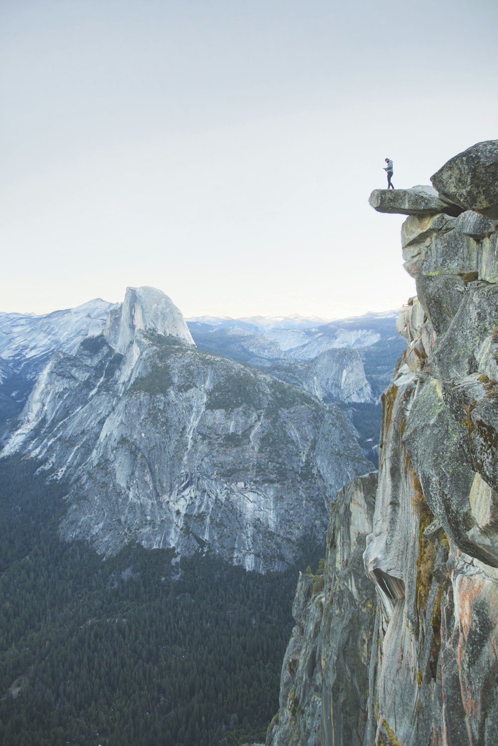 person standing on rock formation during daytime