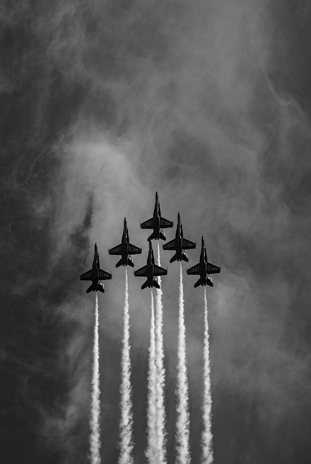 four fighter planes in grayscale photography