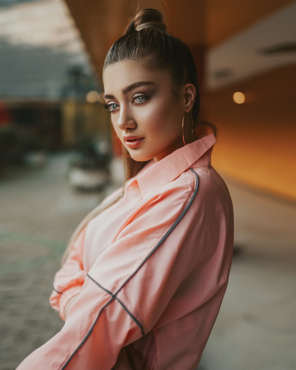 woman in pink robe standing on road during daytime