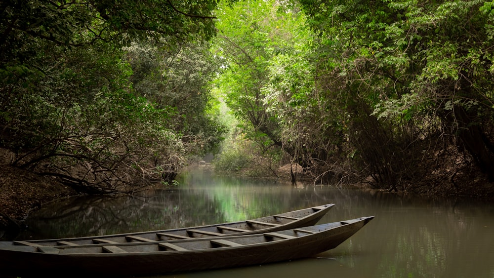 brown wooden boat on river during daytime