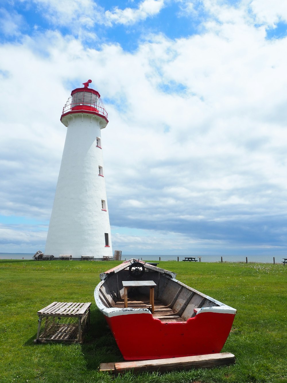 red and white lighthouse under cloudy sky during daytime