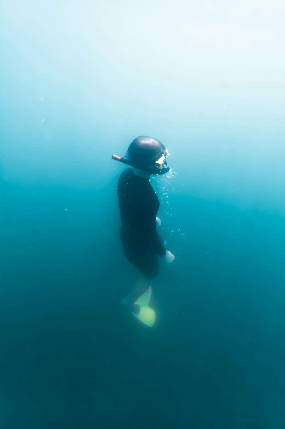 person in black wetsuit in water