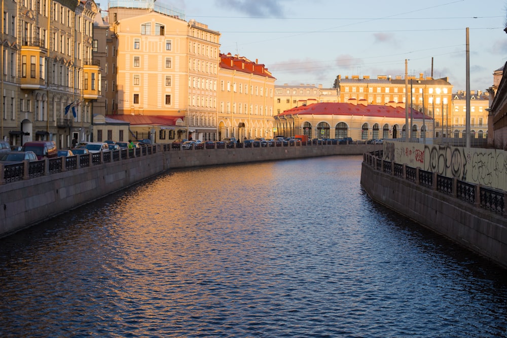 white and brown concrete building beside river during daytime