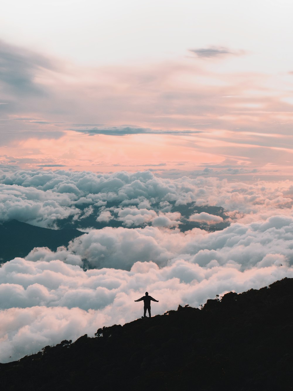 person standing on top of mountain during daytime