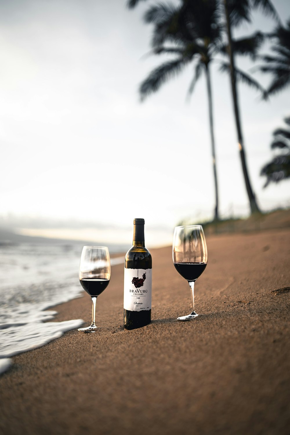 wine bottle on beach shore during daytime