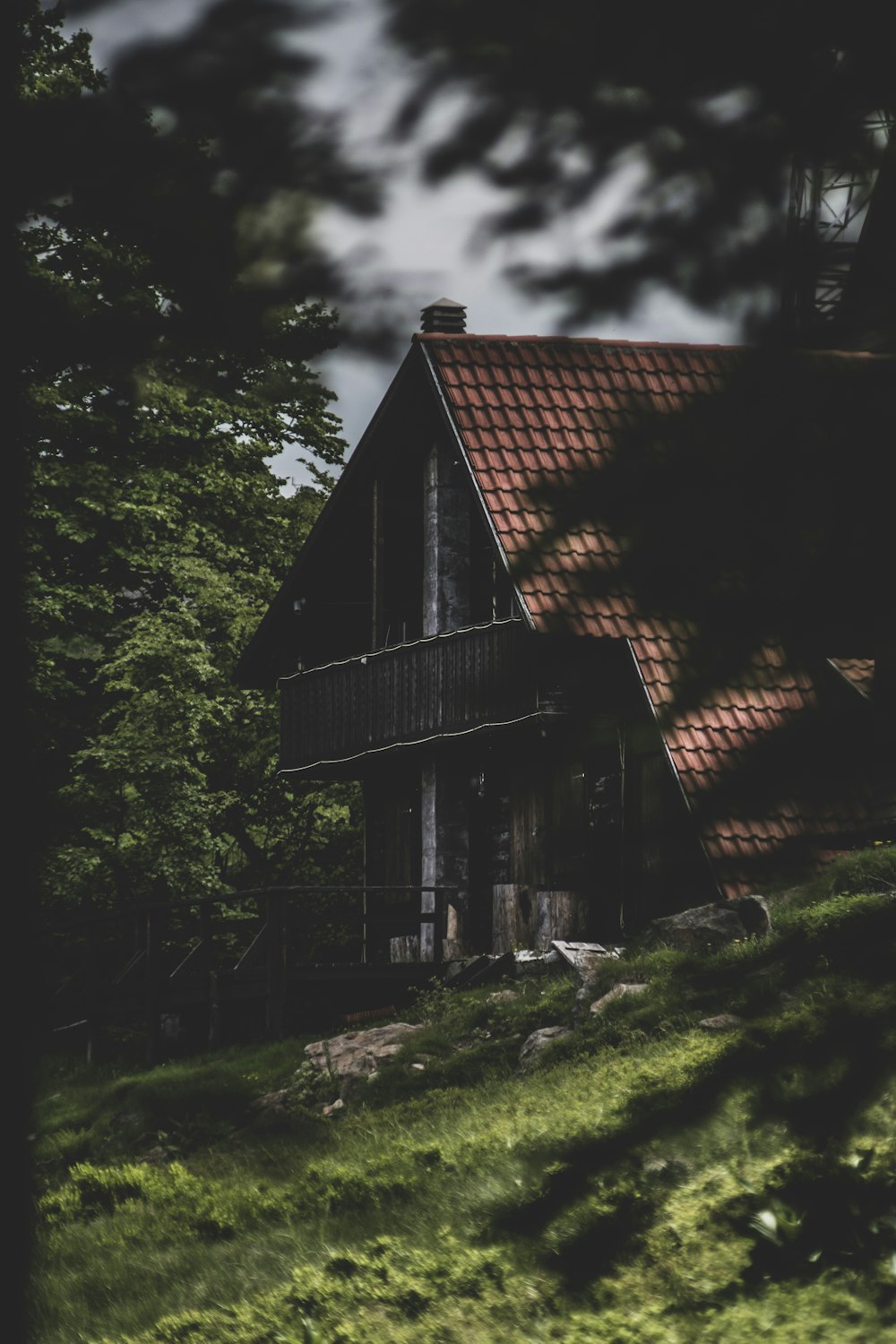 brown wooden house near green trees during daytime