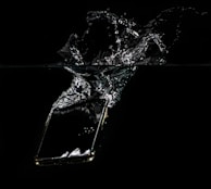 A waterproof phone pouch floating on a crystal-clear pool surface with a smartphone inside.